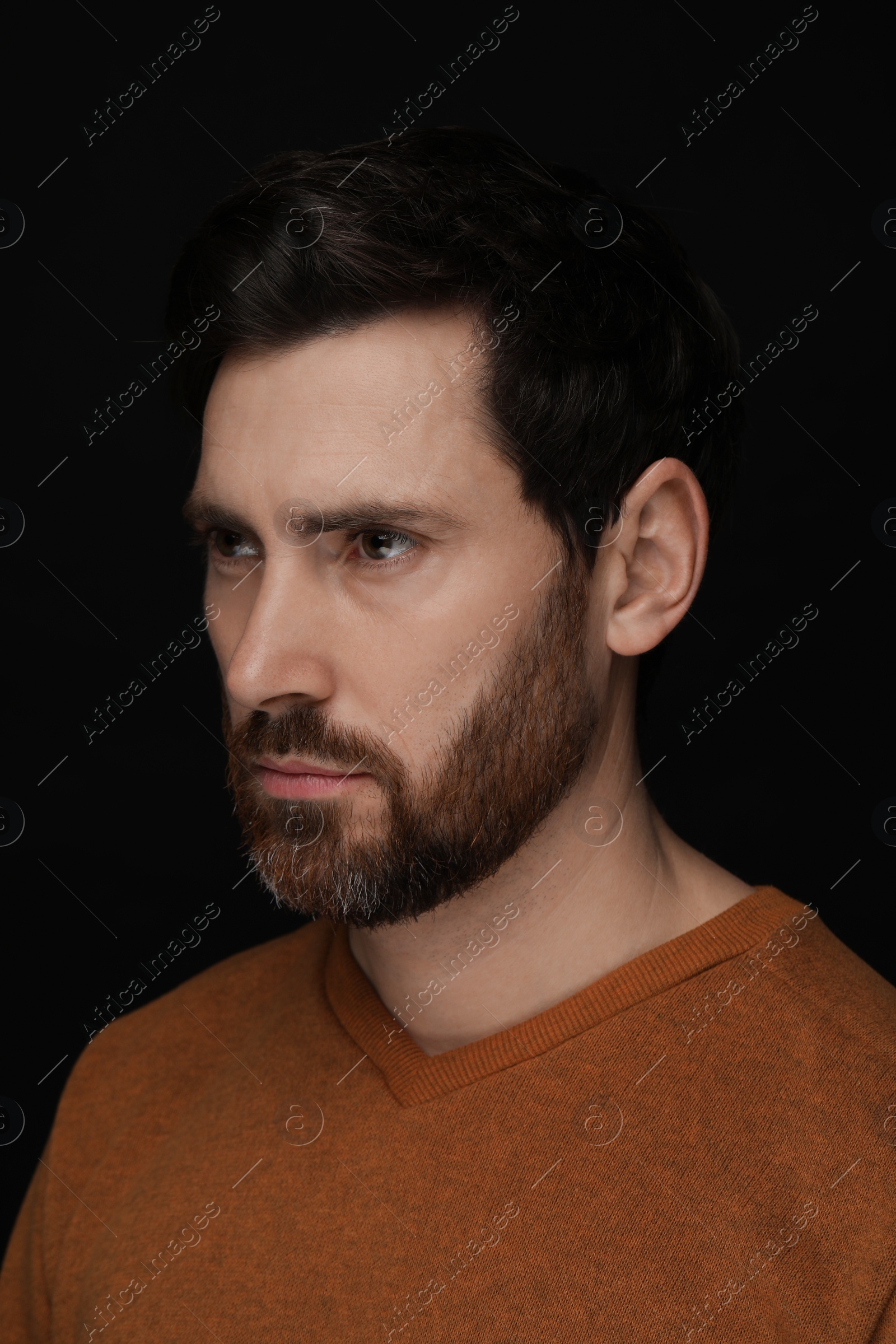 Photo of Evil eye. Man with scary eyes on black background