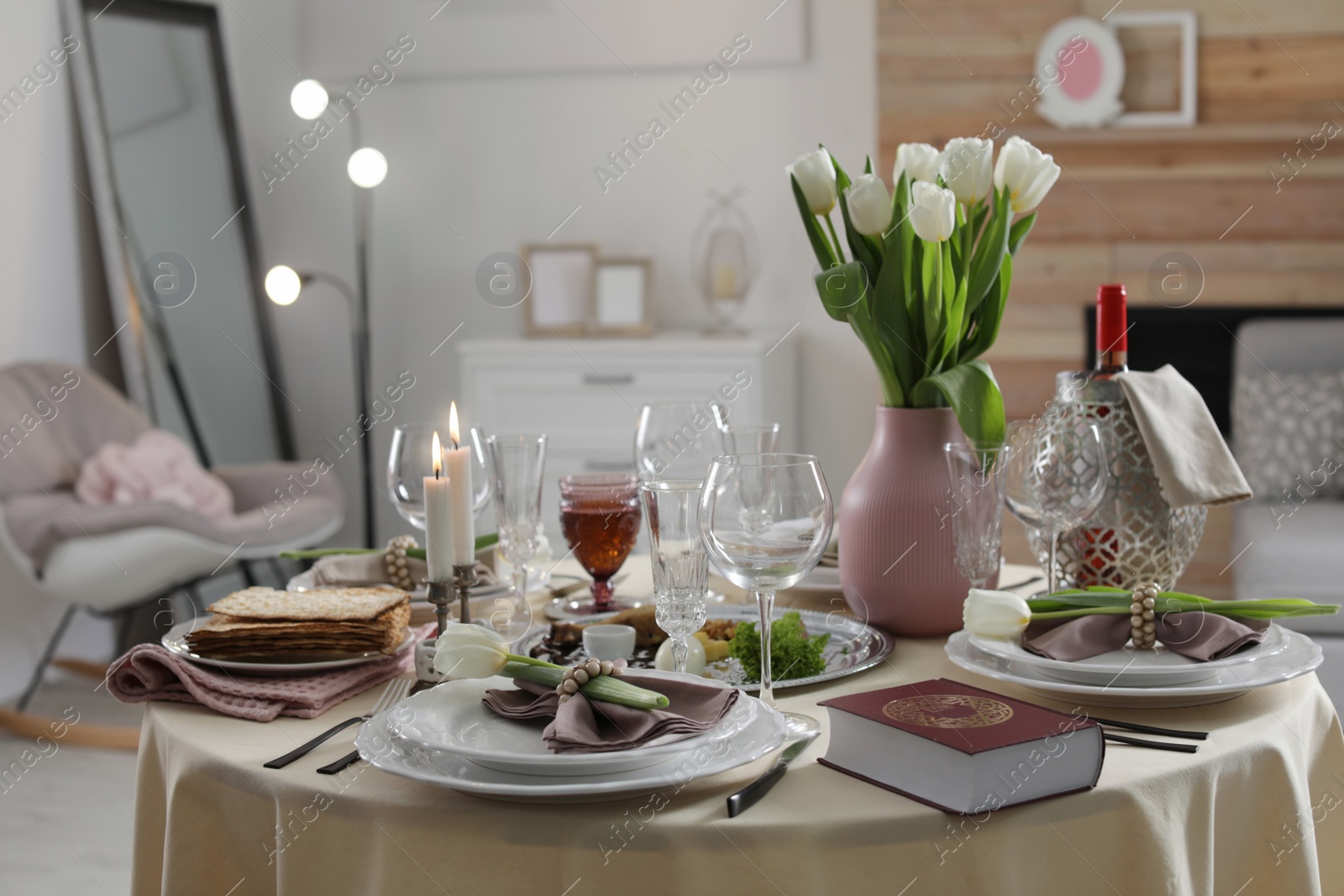 Photo of Festive Passover table setting with Torah at home. Pesach celebration