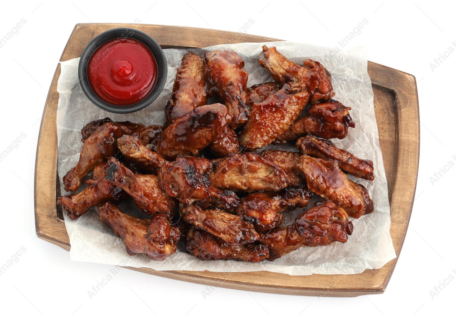 Photo of Tasty chicken wings and ketchup isolated on white, top view