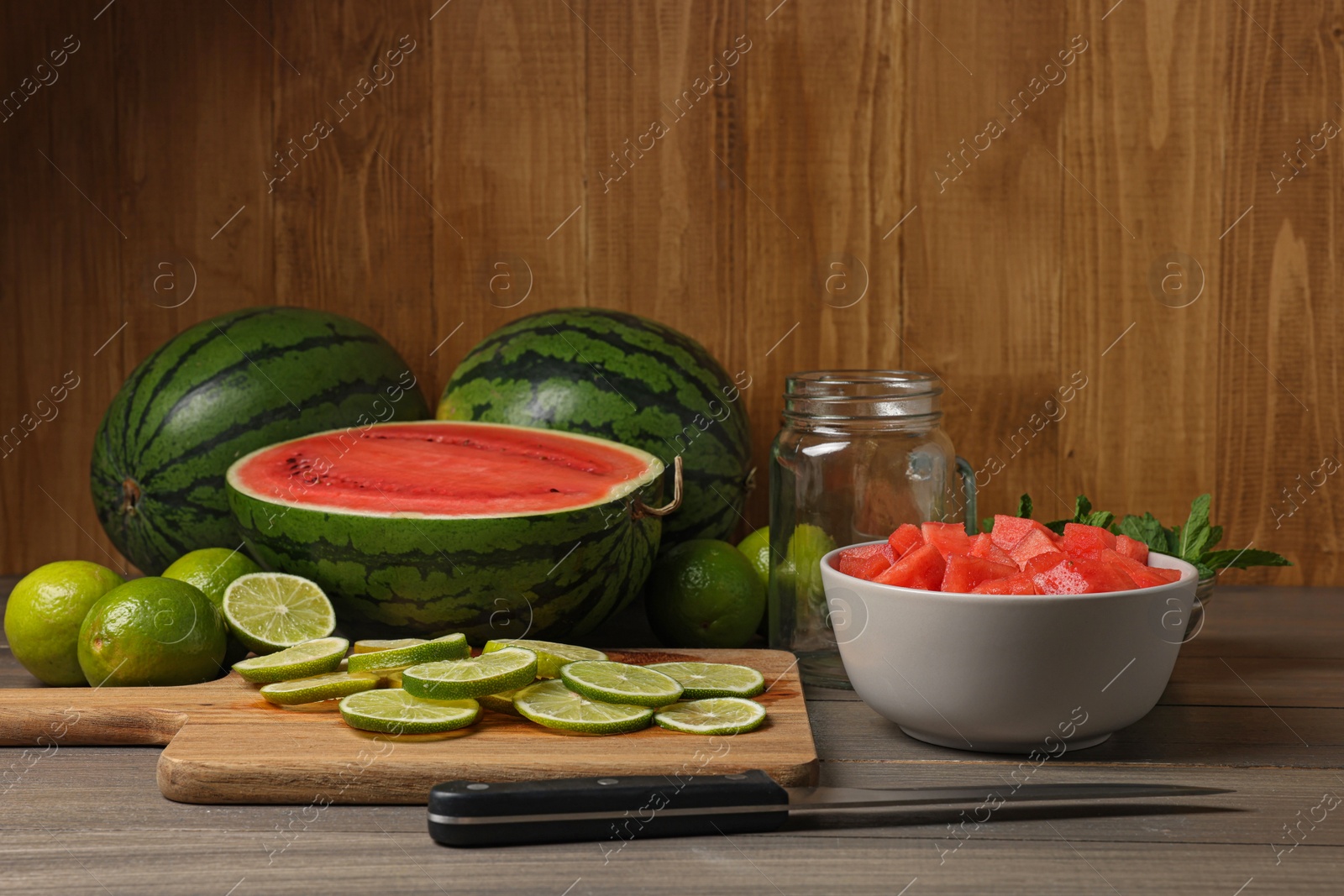 Photo of Fresh ingredients for making watermelon drink with lime on wooden table