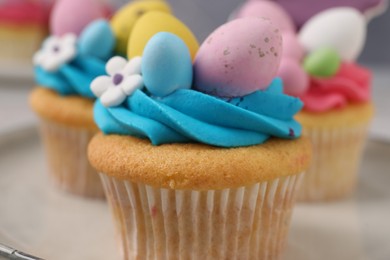 Photo of Tasty decorated Easter cupcakes on table, closeup