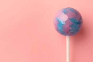 Photo of Tasty lollipop on pink background, top view. Space for text