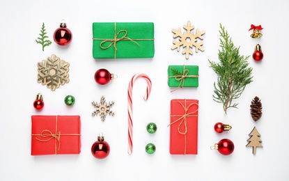 Photo of Flat lay composition with Christmas gifts and festive decor on white background