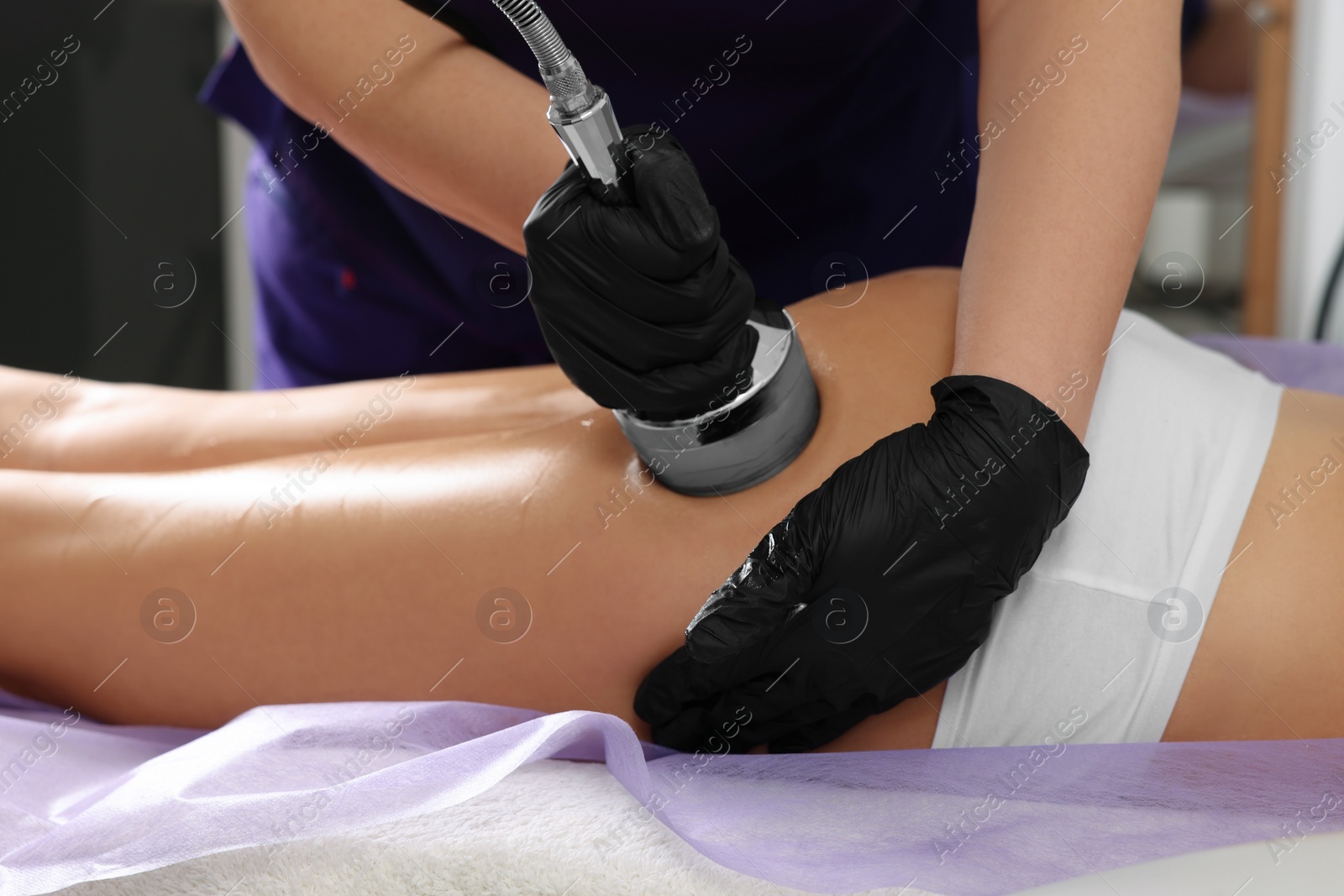 Photo of Woman undergoing radio frequency lifting procedure in beauty salon, closeup