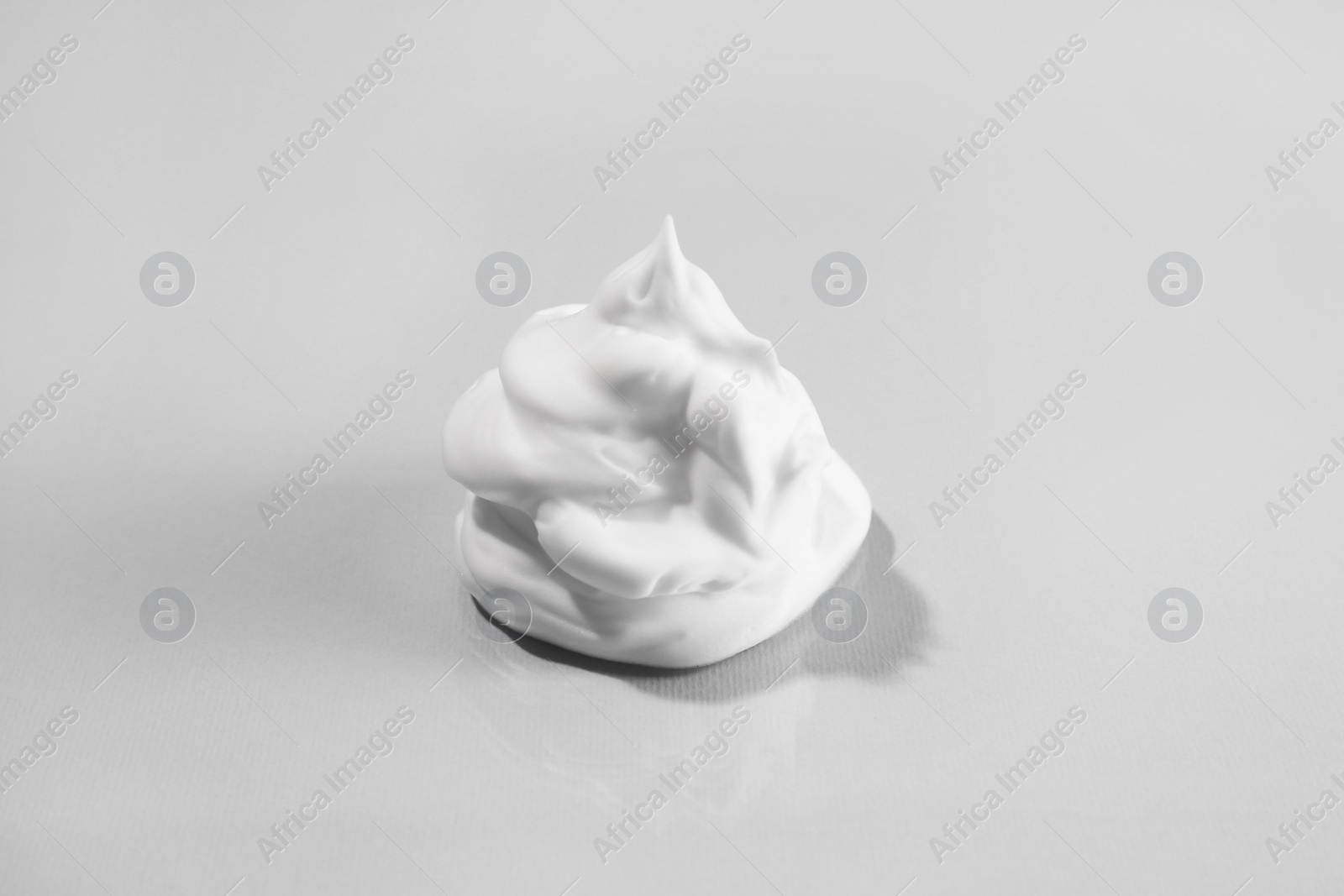 Photo of Sample of cleansing foam on light background. Cosmetic product