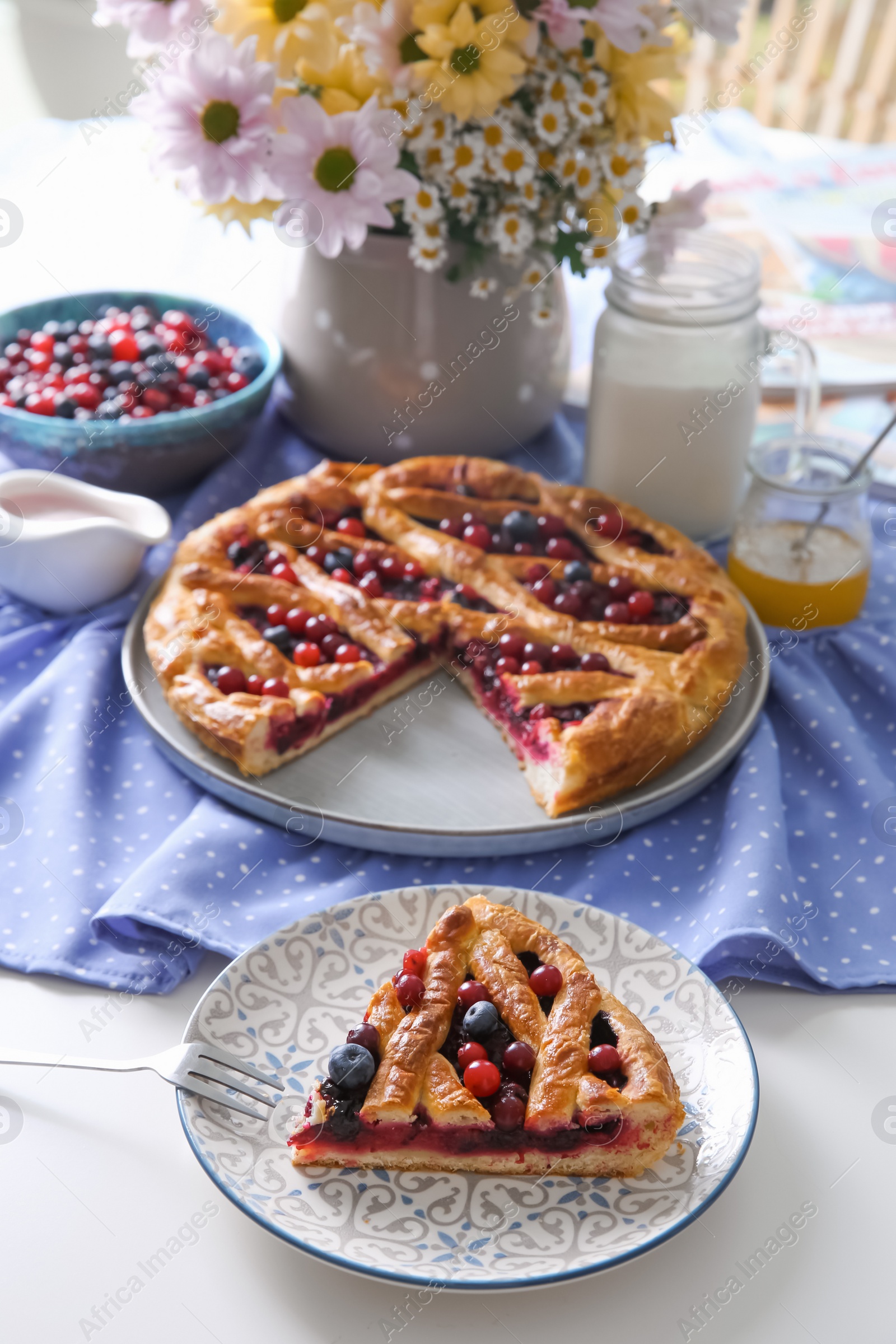 Photo of Delicious currant pie with fresh berries served on white table