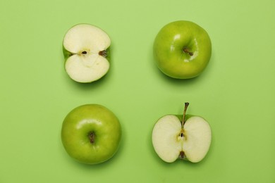 Photo of Fresh ripe apples on green background, flat lay