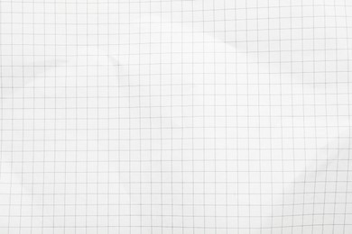 Checkered notebook sheet as background, top view