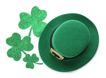 Photo of Leprechaun's hat and decorative clover leaves on white background, top view. St. Patrick's day celebration