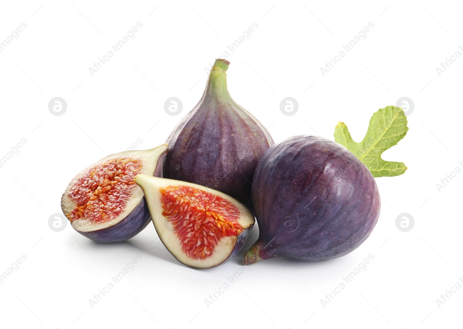 Photo of Whole and cut purple figs on white background