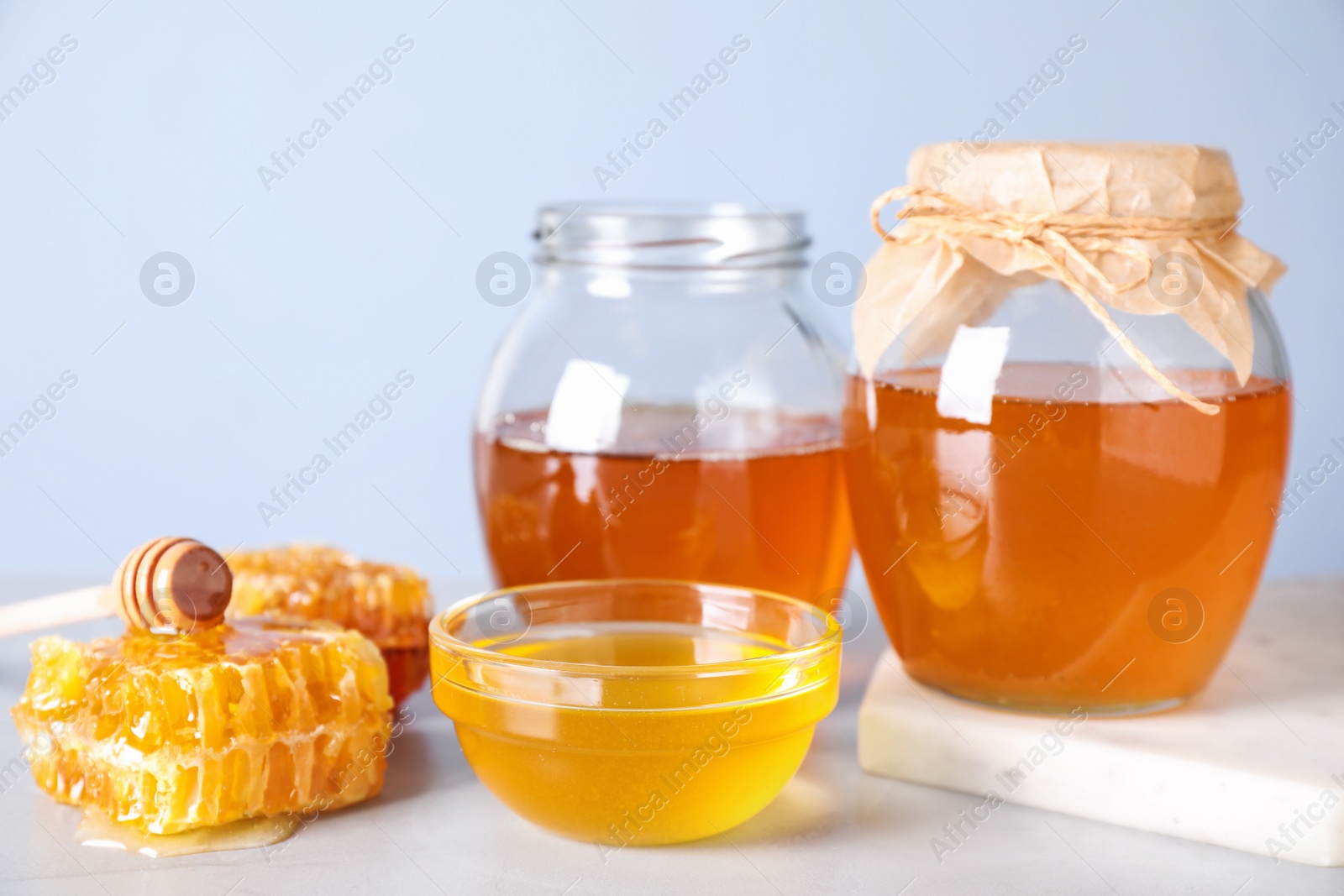 Photo of Tasty fresh organic honey on white table