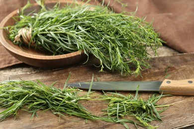 Fresh whole and cut tarragon sprigs on table