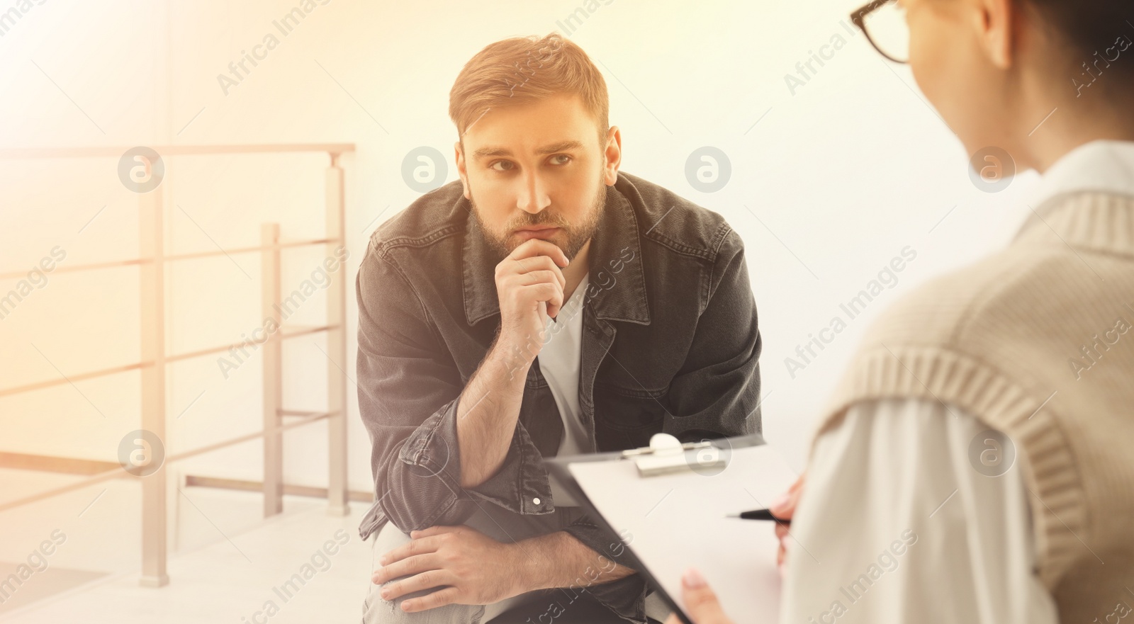 Image of Psychotherapist working with young man indoors. Banner design