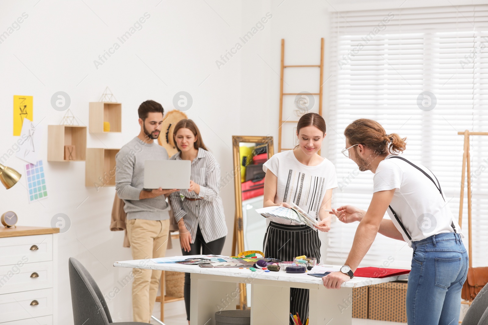 Photo of Fashion designers creating new clothes in studio