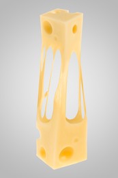 Tasty cheese stretching in air on grey background