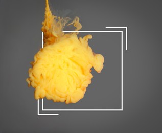 Image of Splash of yellow ink and frame on grey background