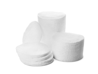 Photo of Piles of cotton pads on white background