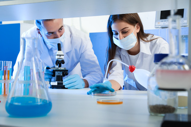 Photo of Scientists doing research and analysis with microscope in laboratory