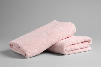 Photo of Fresh soft folded towels on light background