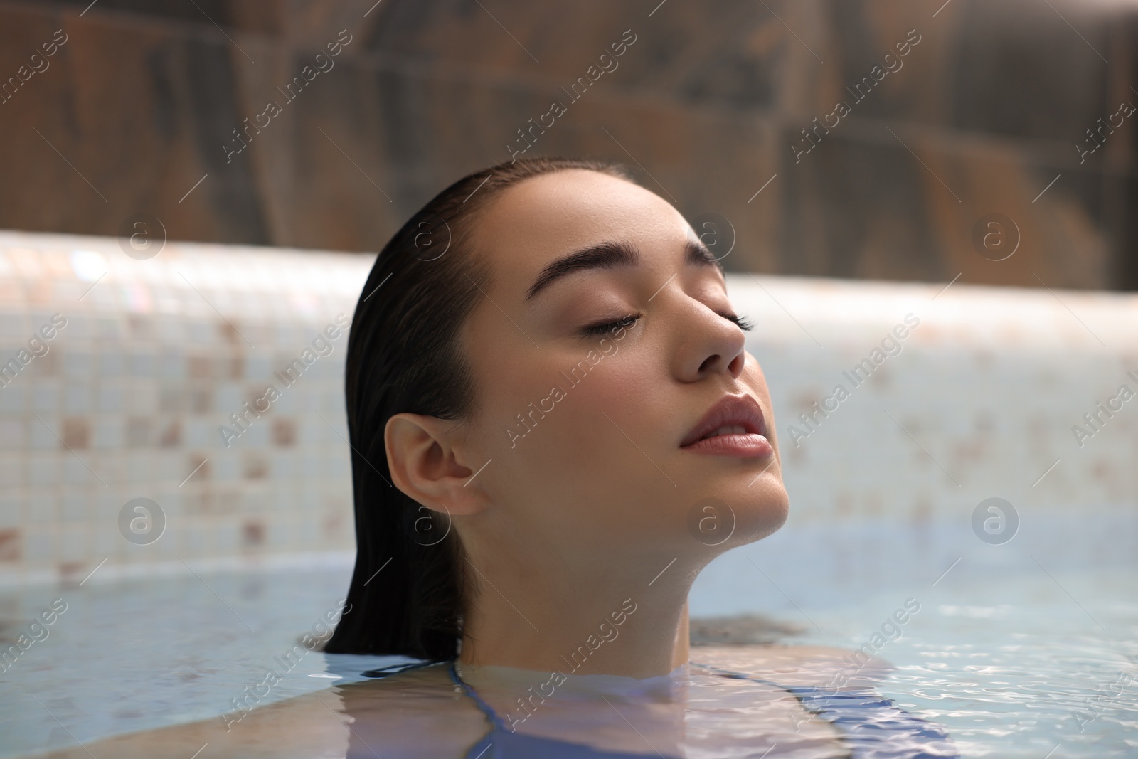 Photo of Beautiful woman relaxing in spa swimming pool