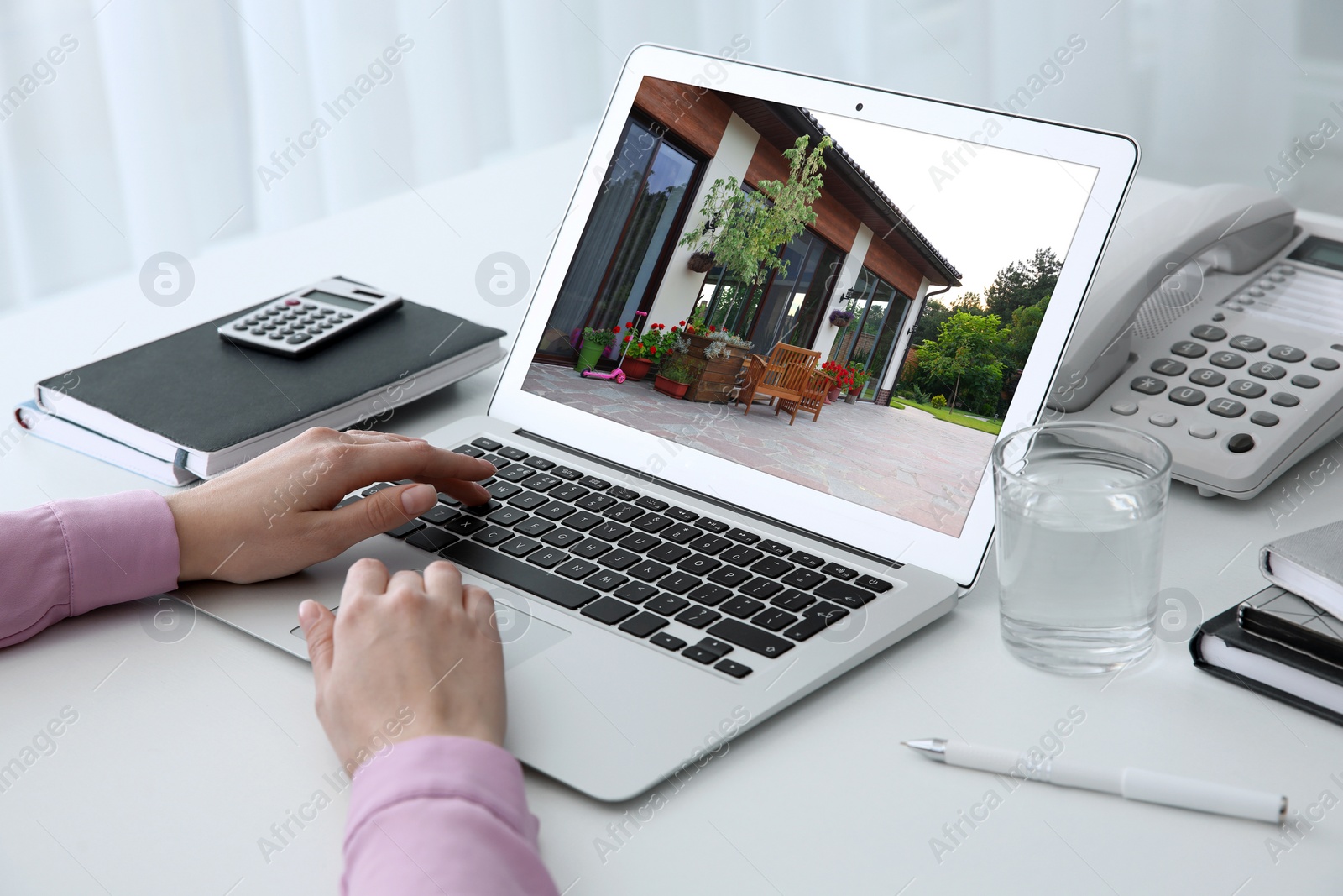 Image of Businesswoman or real estate agent looking through online property portfolio, closeup