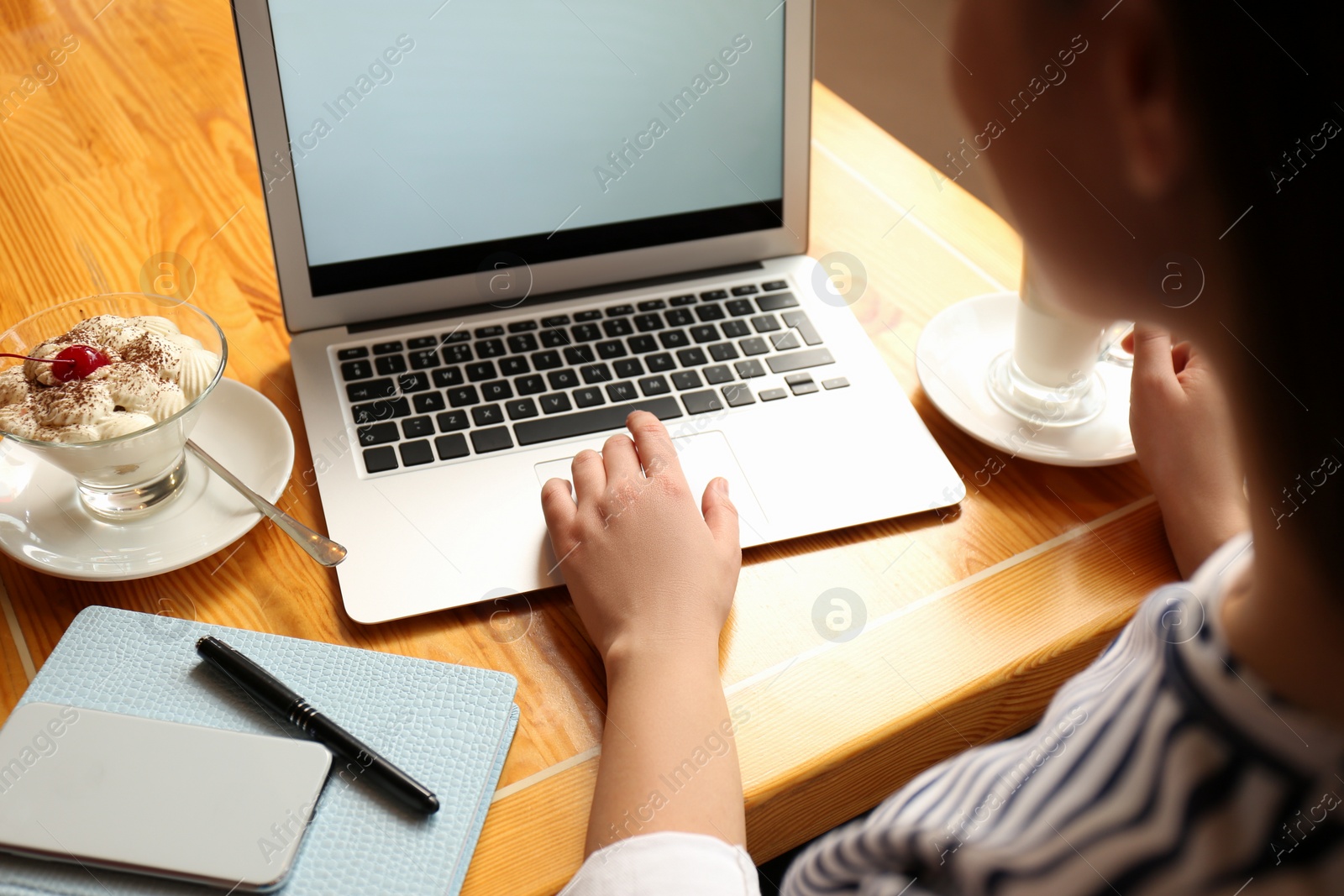 Photo of Blogger working with laptop in cafe, closeup