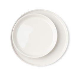 Beautiful empty ceramic plates on white background, top view