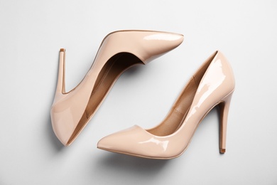 Pair of beautiful shoes on light background, top view