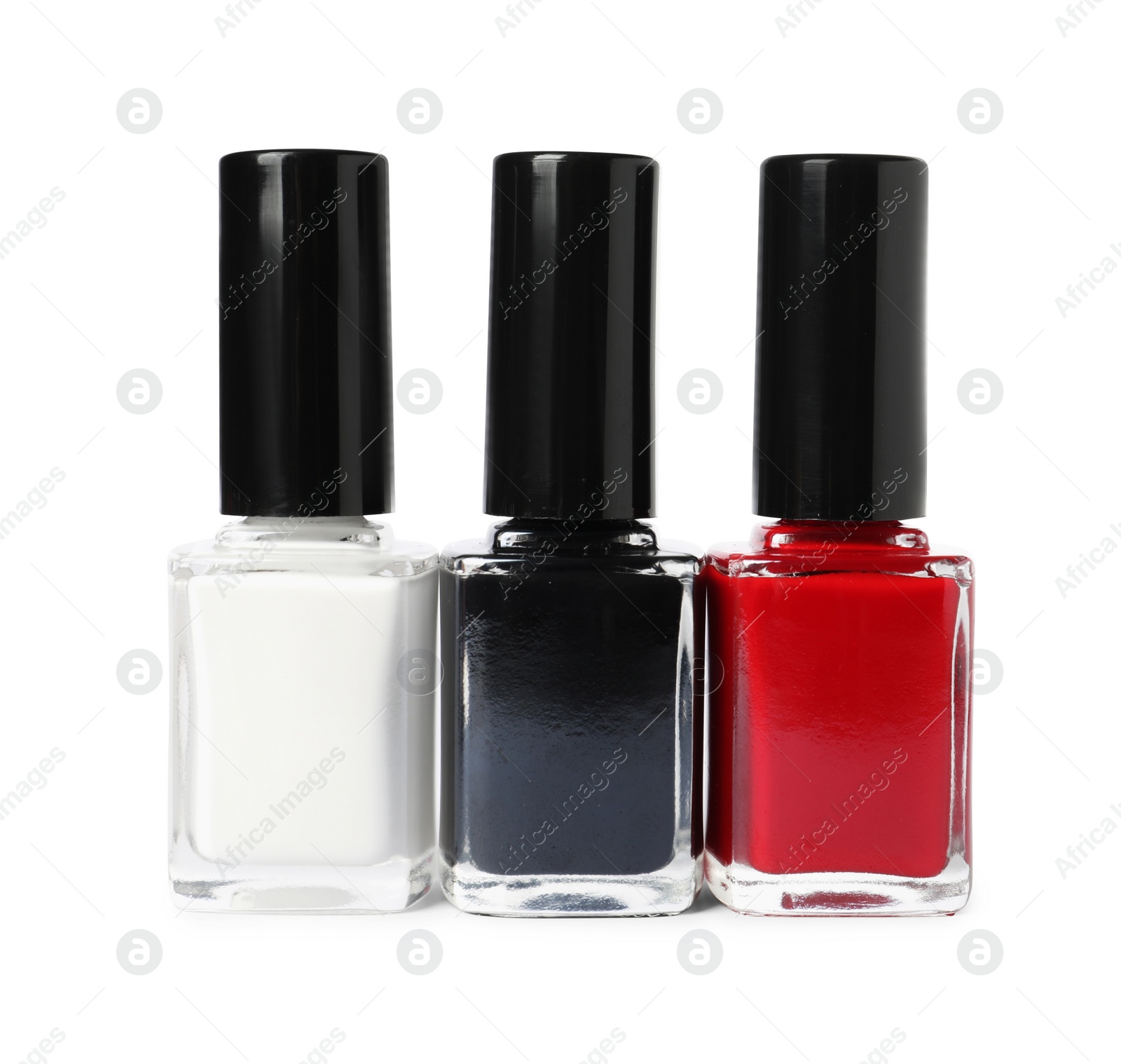 Photo of Bright nail polishes in bottles isolated on white