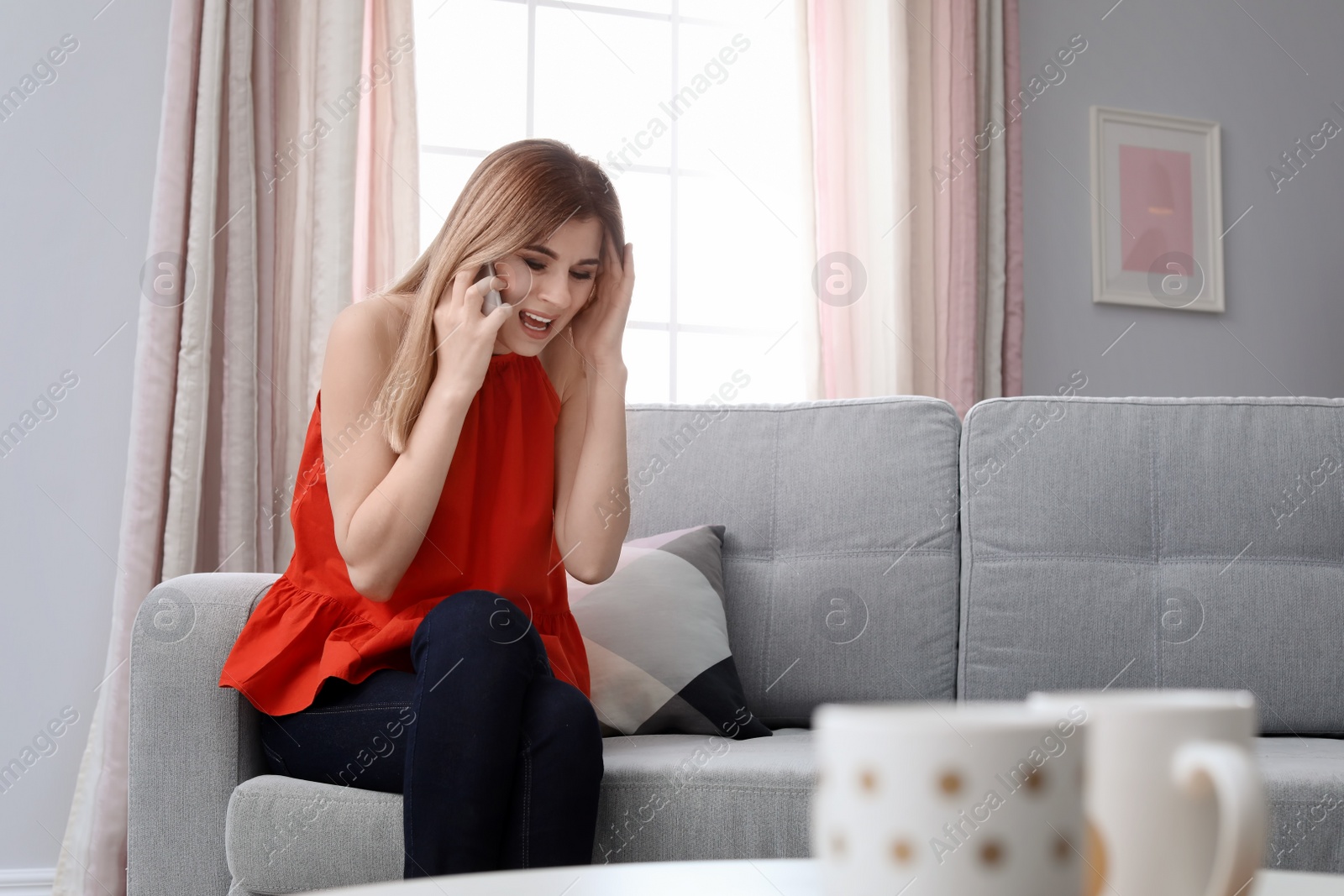 Photo of Woman arguing on mobile phone at home