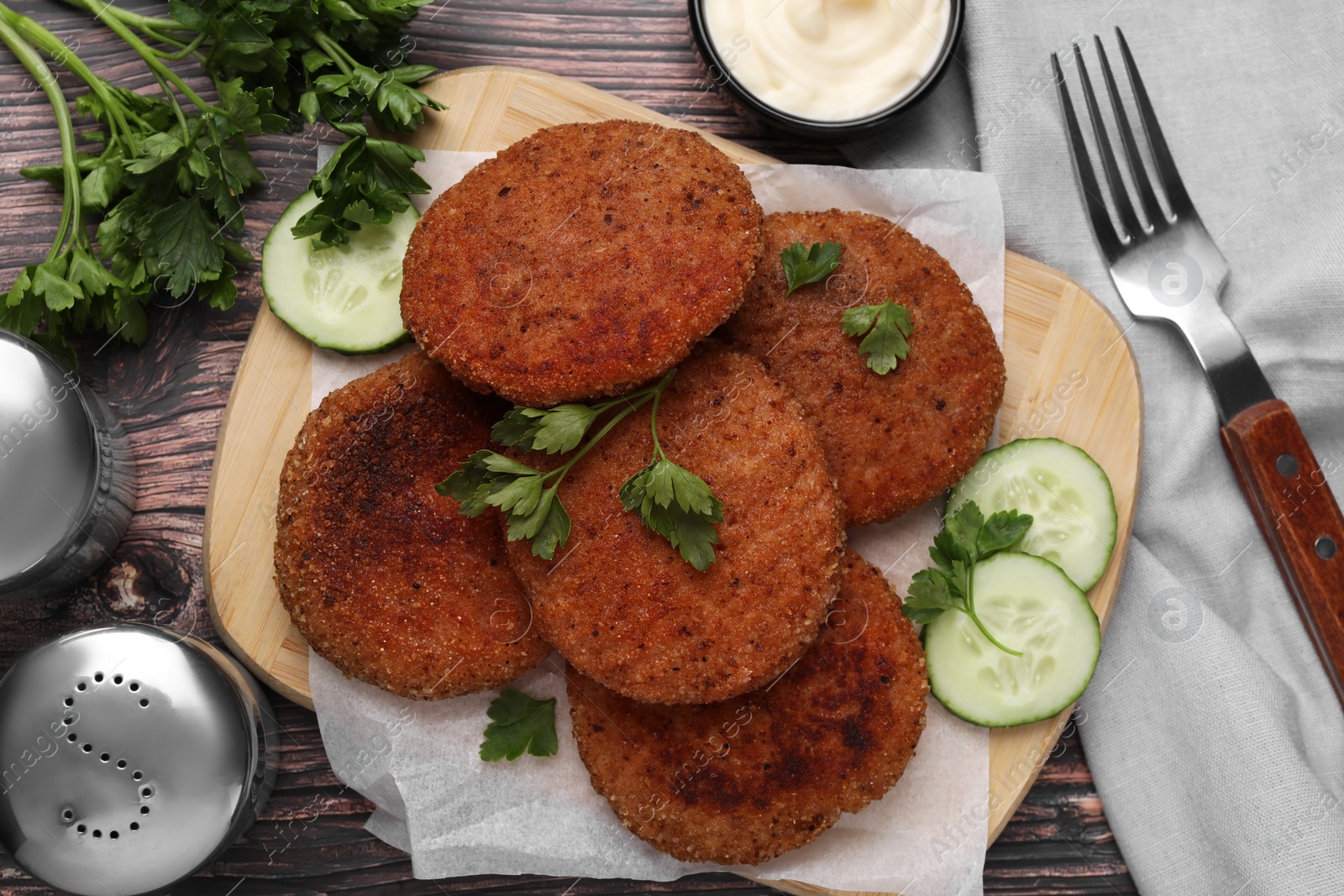 Photo of Tasty vegan cutlets served on wooden table, flat lay