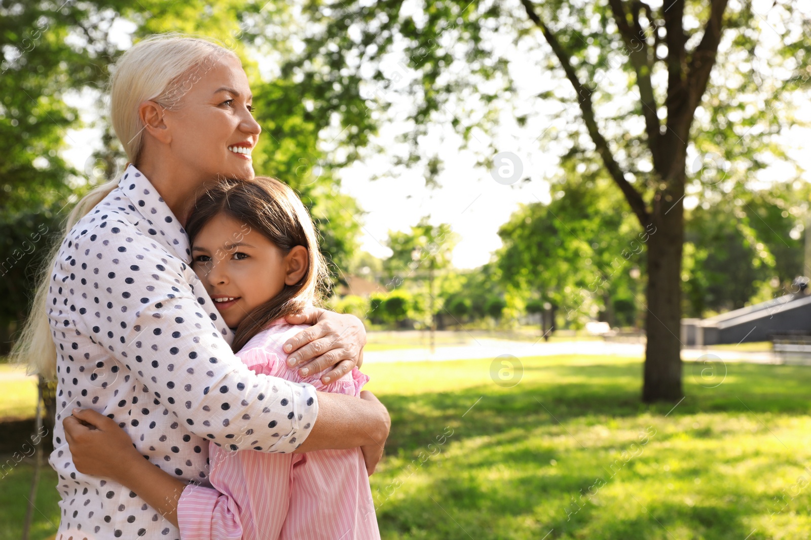 Photo of Mature woman with her little granddaughter in park