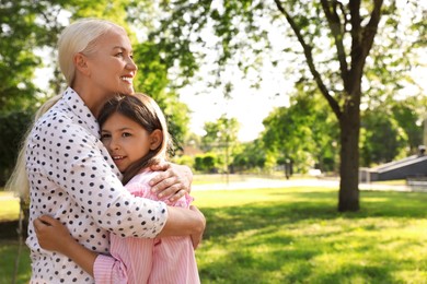 Photo of Mature woman with her little granddaughter in park