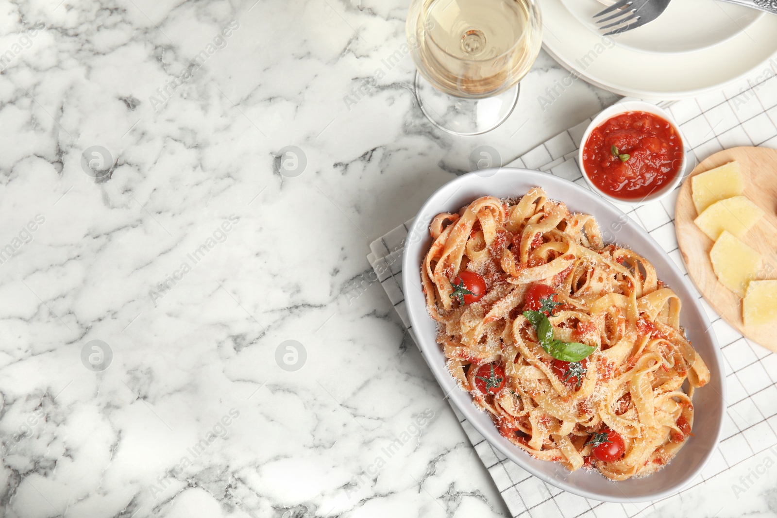 Photo of Flat lay composition with tasty pasta on white marble table, space for text