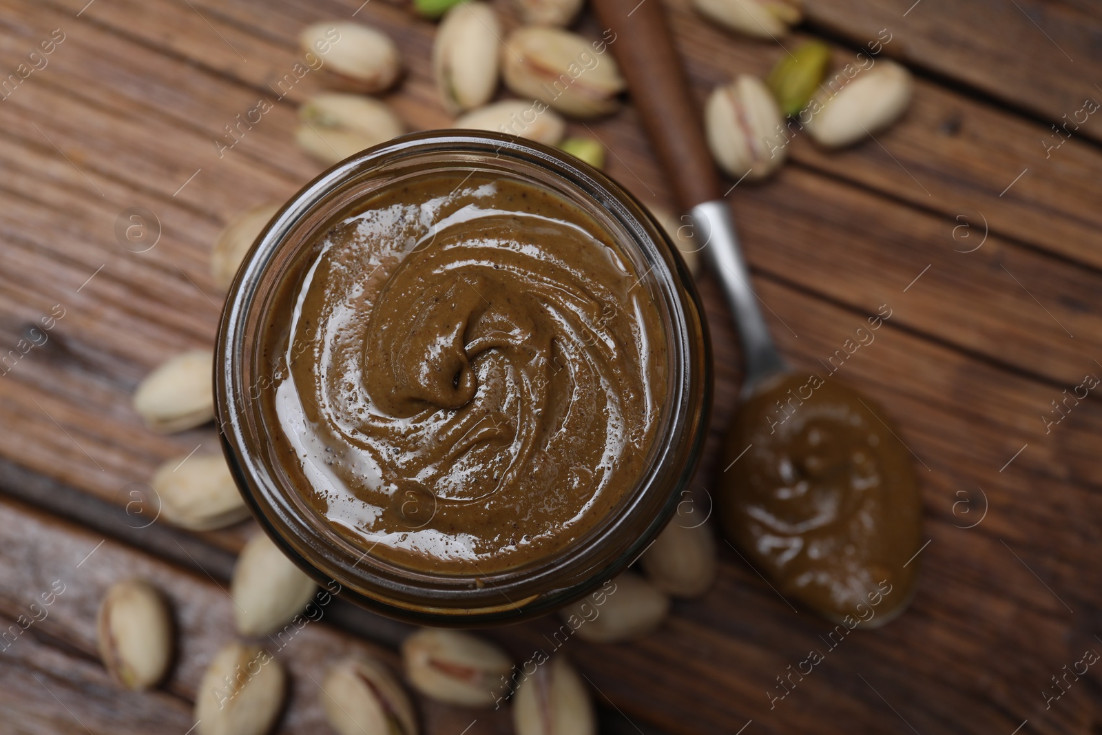 Photo of Tasty pistachio nut paste on table, top view