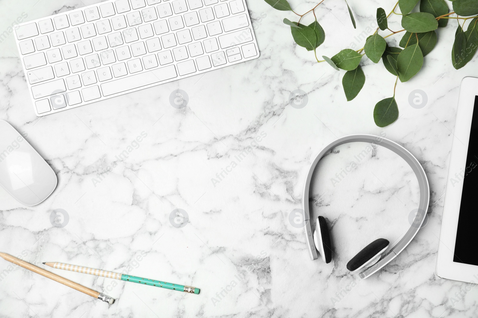 Photo of Flat lay composition with headphones, computer keyboard and space for text on marble background