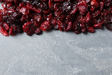 Photo of Tasty cranberries on grey background, top view with space for text. Dried fruit as healthy snack