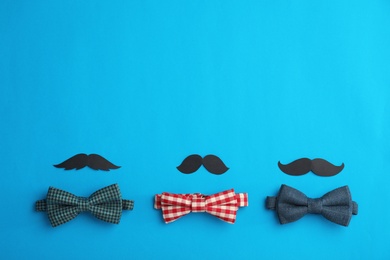 Flat lay composition with paper moustaches, bow ties and space for text on color background. Happy Father's Day