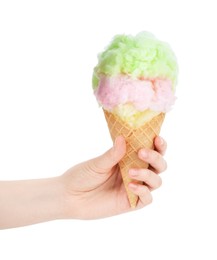 Photo of Woman holding waffle cone with cotton candy on white background, closeup