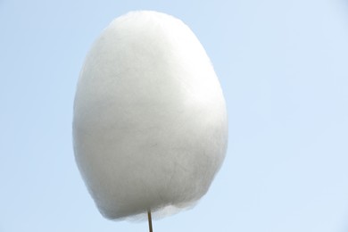 One sweet cotton candy against blue sky, closeup