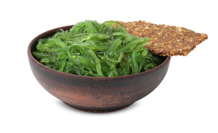 Photo of Tasty seaweed salad in bowl and crispbread isolated on white