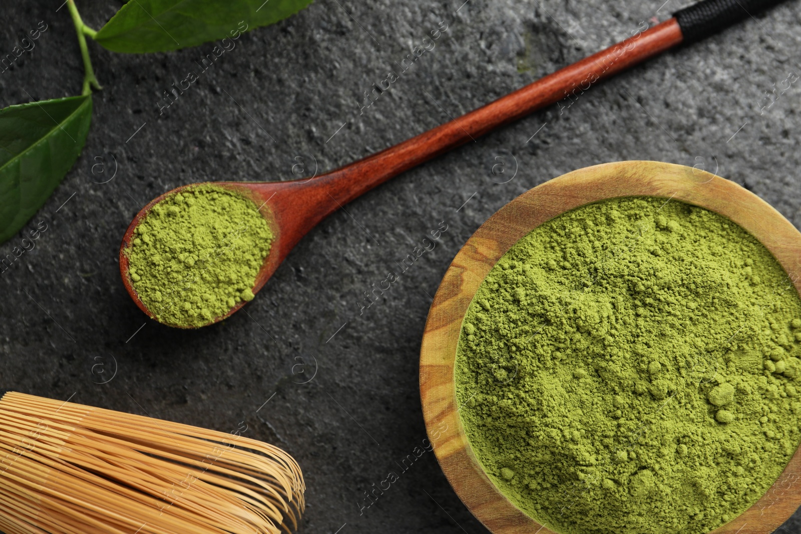 Photo of Flat lay composition with green matcha powder on grey table