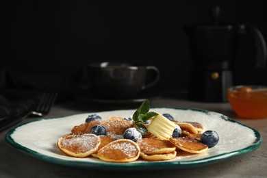 Photo of Cereal pancakes with blueberries and butter on grey table