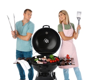 Happy couple cooking on barbecue grill, white background