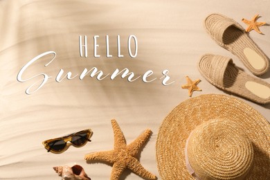 Image of Hello Summer. Different beach accessories on sand, flat lay