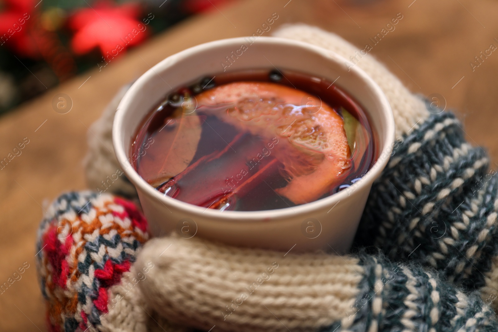 Photo of Woman with cup of mulled wine at counter, closeup