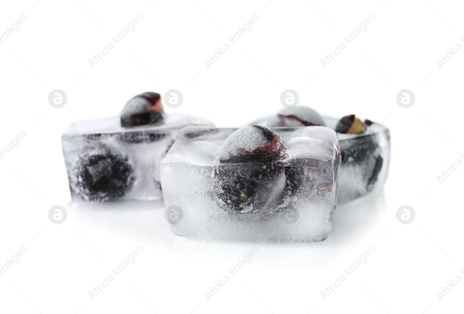 Photo of Fresh berries frozen in ice cubes on white background