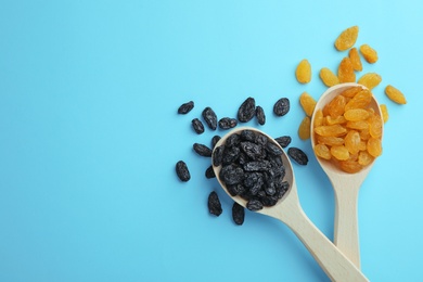 Photo of Spoons and raisins on color background, top view with space for text. Dried fruit as healthy snack