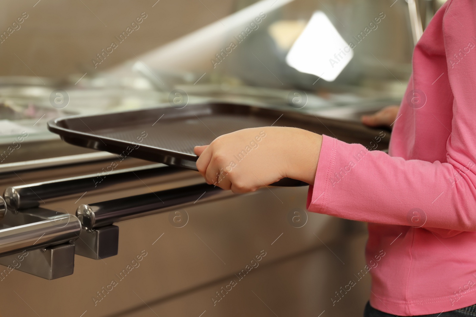 Photo of Little girl near serving line in canteen, closeup. School food