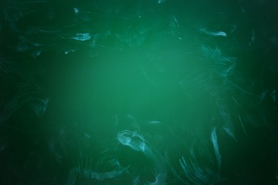 Dirty green chalkboard as background. Vignette effect